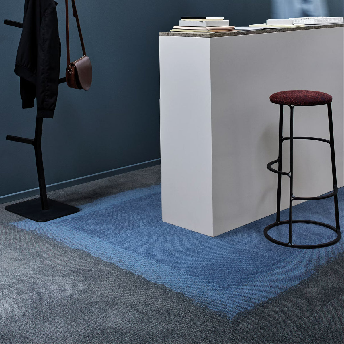 Interface Composure Edge carpet tiles in Sapphire/Diffuse with Composure Sapphire and Diffuse beside a reception desk
