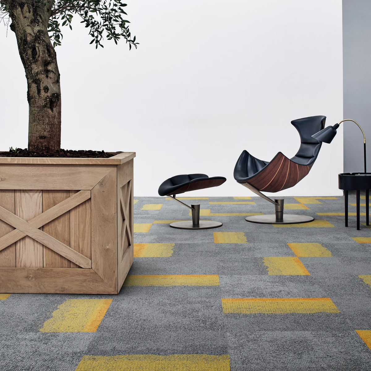Interface Composure Edge carpet tiles in Sunburst/Seclusion with Composure Seclusion beside a lounge chair