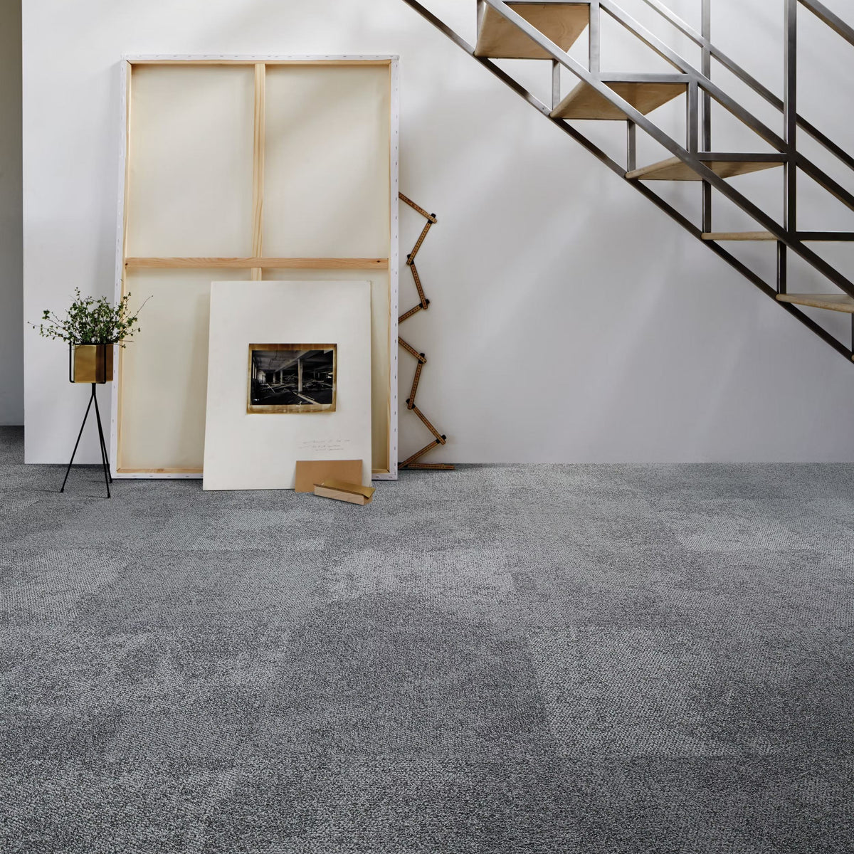 Interface Composure carpet tiles in Seclusion beneath an open staircase