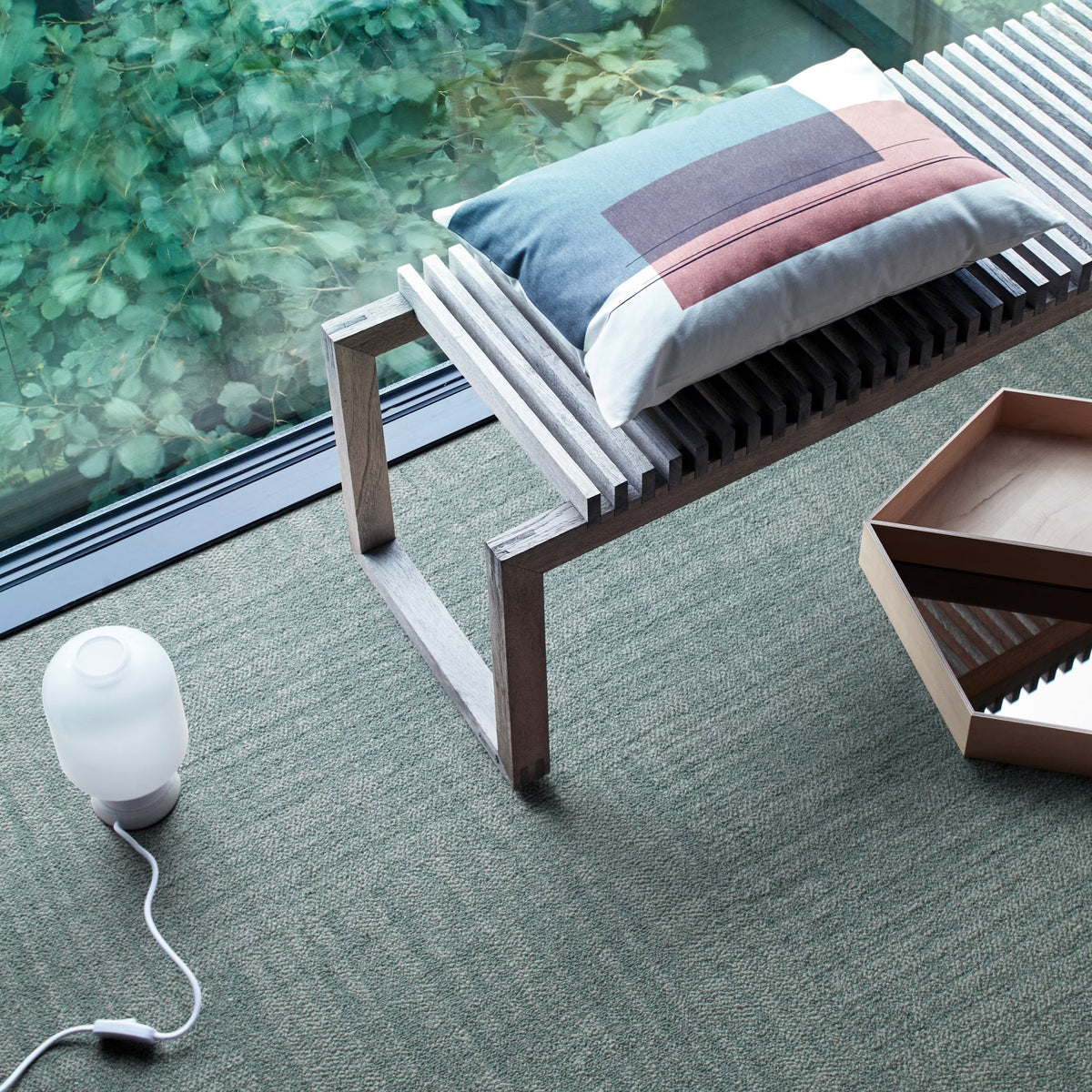 Interface Contemplation carpet tiles in Element beside a window with a slatted bench