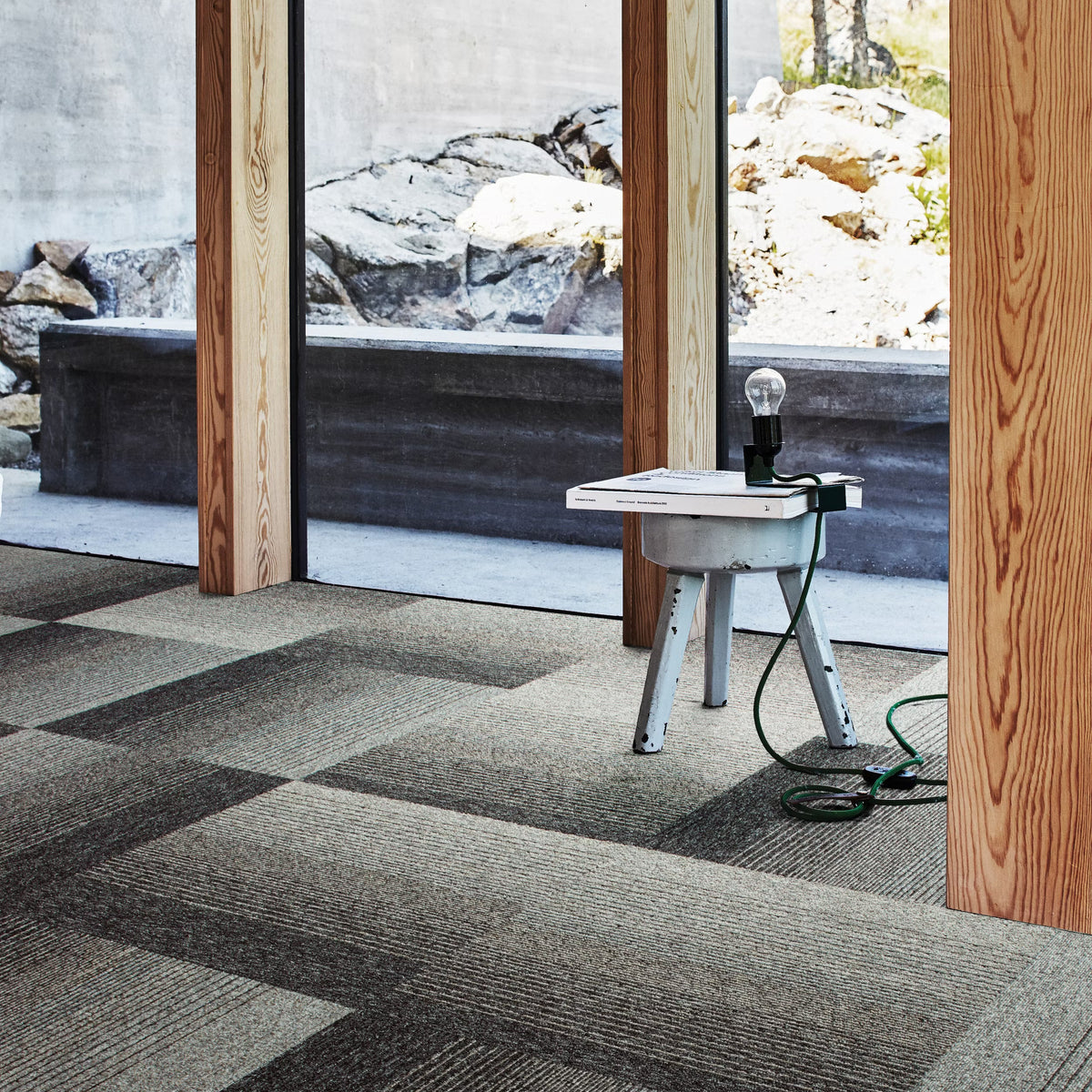 Interface Employ Lines carpet tiles in Formation beside floor-to-ceiling windows